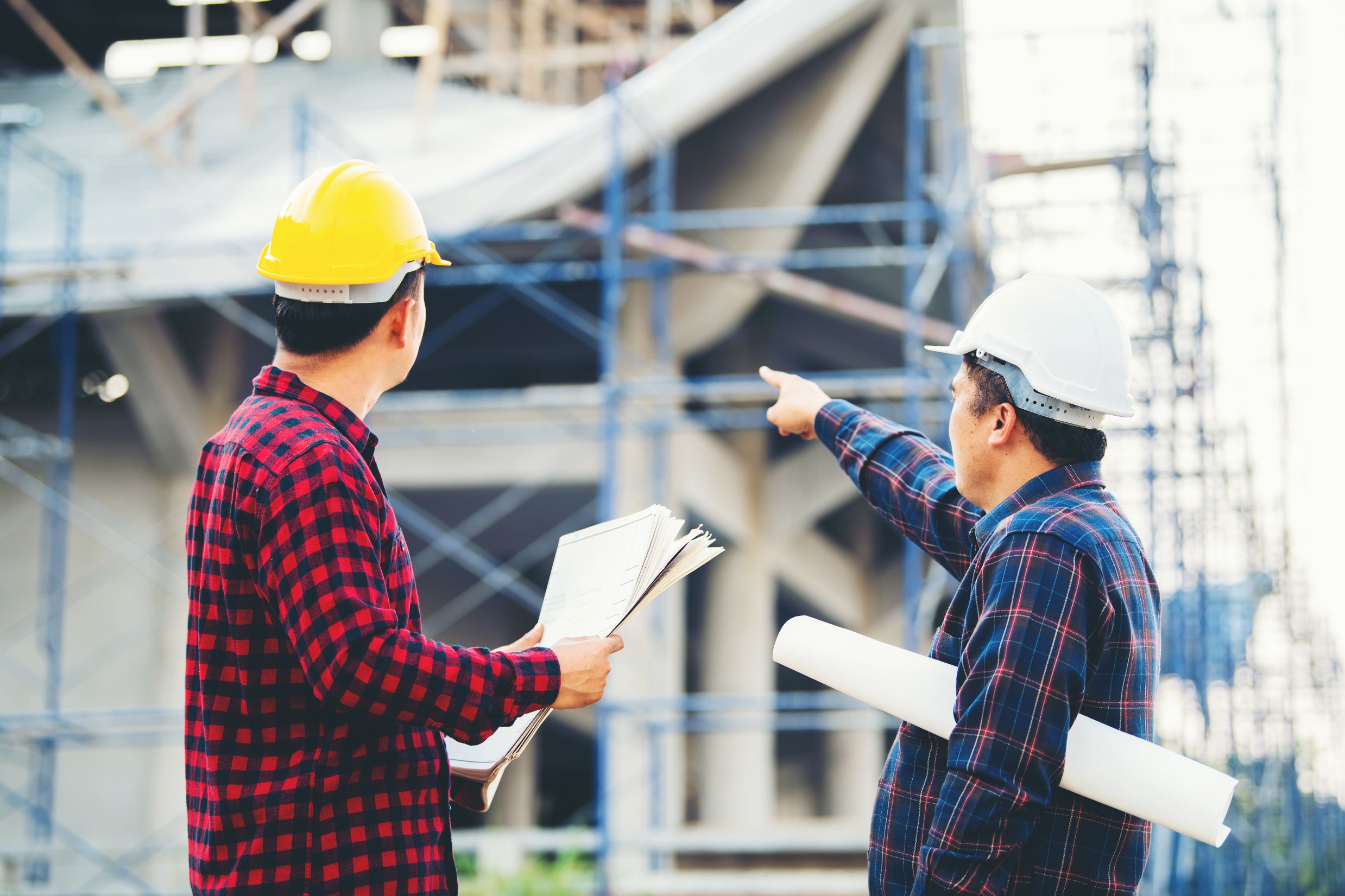 Construction workers holding plans